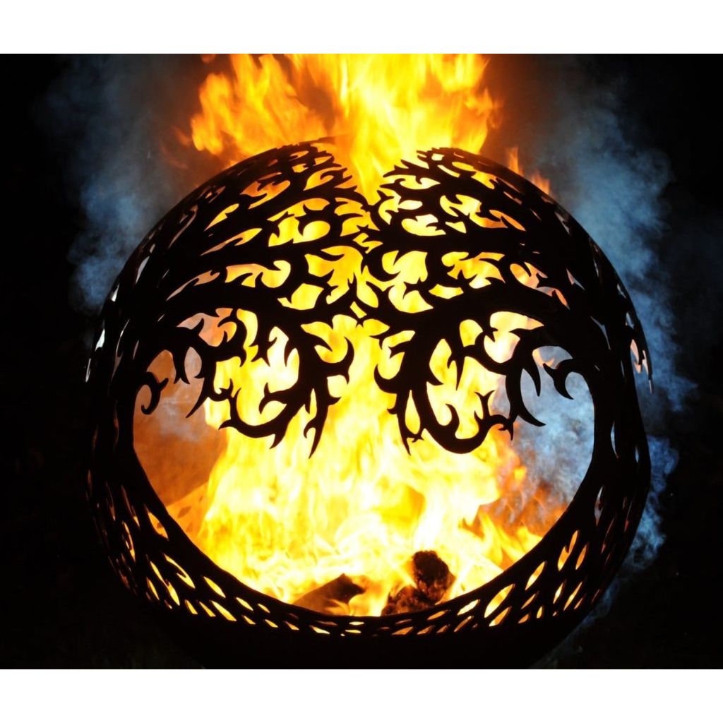 tree of life fire container with large flames at night