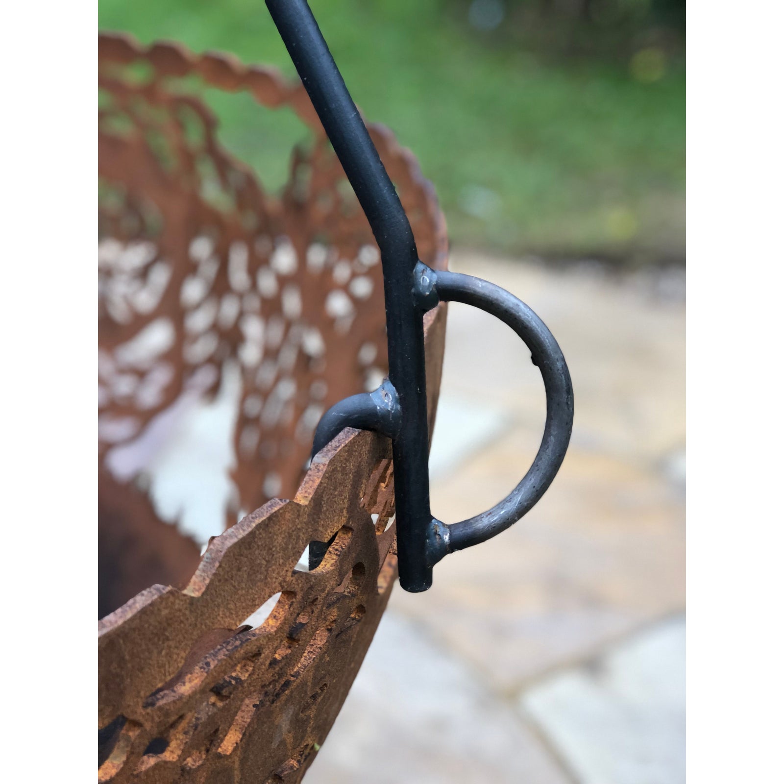 close up of tipod cooking stand attached to hanging basket