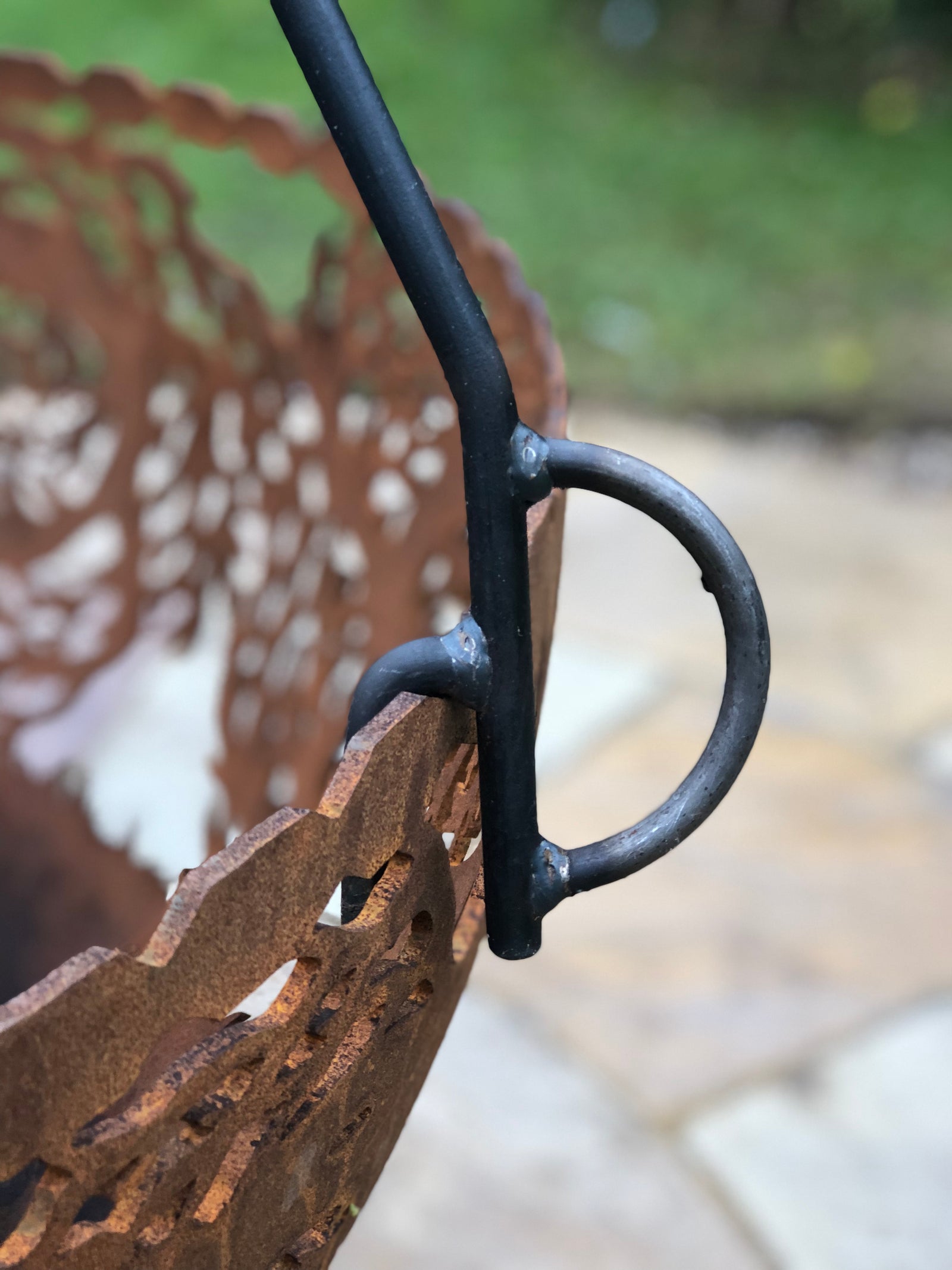 close up of tipod cooking stand attached to hanging basket
