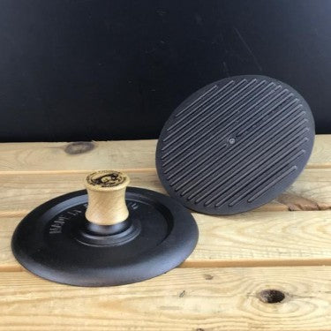 Cast iron steak press with ridged base and wooden handle