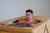 man enjoying wooden hot tub
