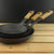 Set of three Netherton Foundry spun iron frying pans with oak handles on a wooden surface