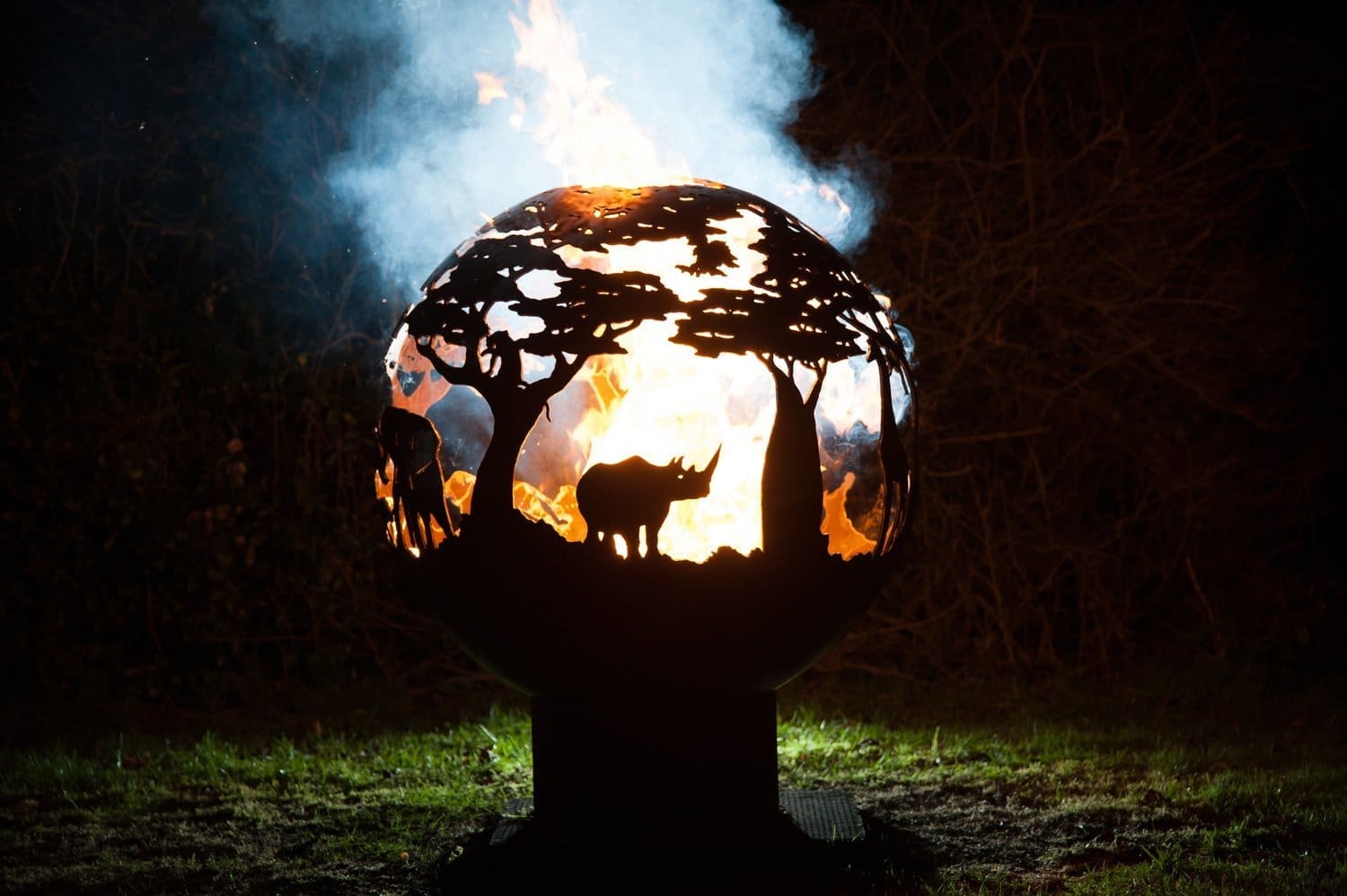 africa style fire bowl with elephants and rhinos with flames