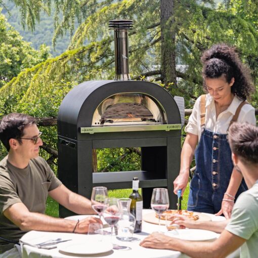 Family enjoying use of clementi pizza oven