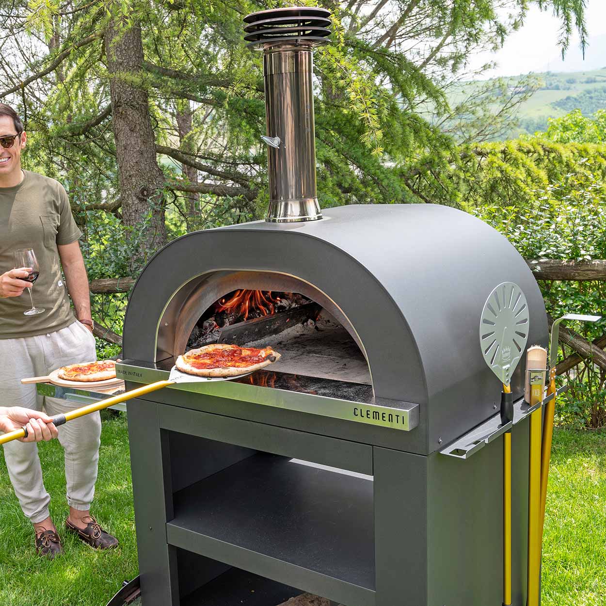 pizza being removed from Clementi oven with infrared thermometer attached