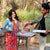 man and woman using outdoor clementi cooking system