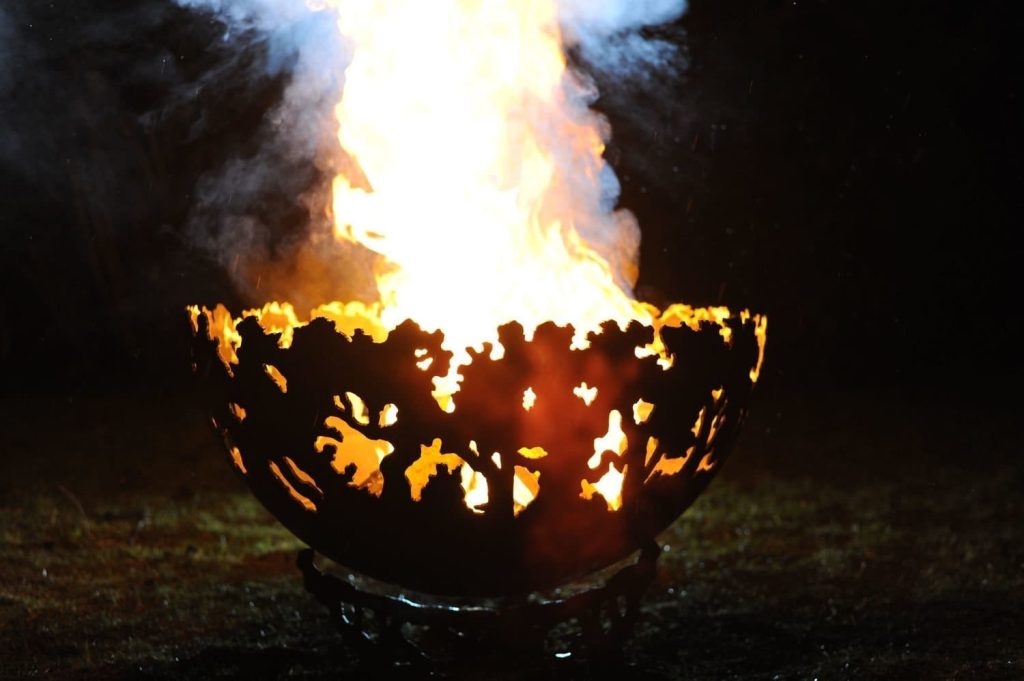 forest fire bowl at night in garden with large flames