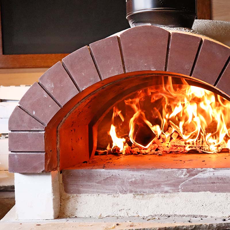 Wood-fired oven with flames inside