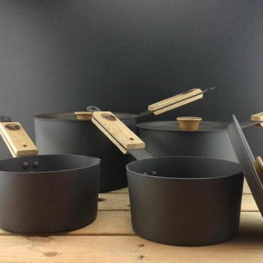 Shropshire‑made spun iron saucepan set with milk pan and oak lids