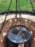 tripod cooking stand with view of cooking grate and wood in burner