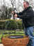 Tripod cooking stand outdoors being assembled 