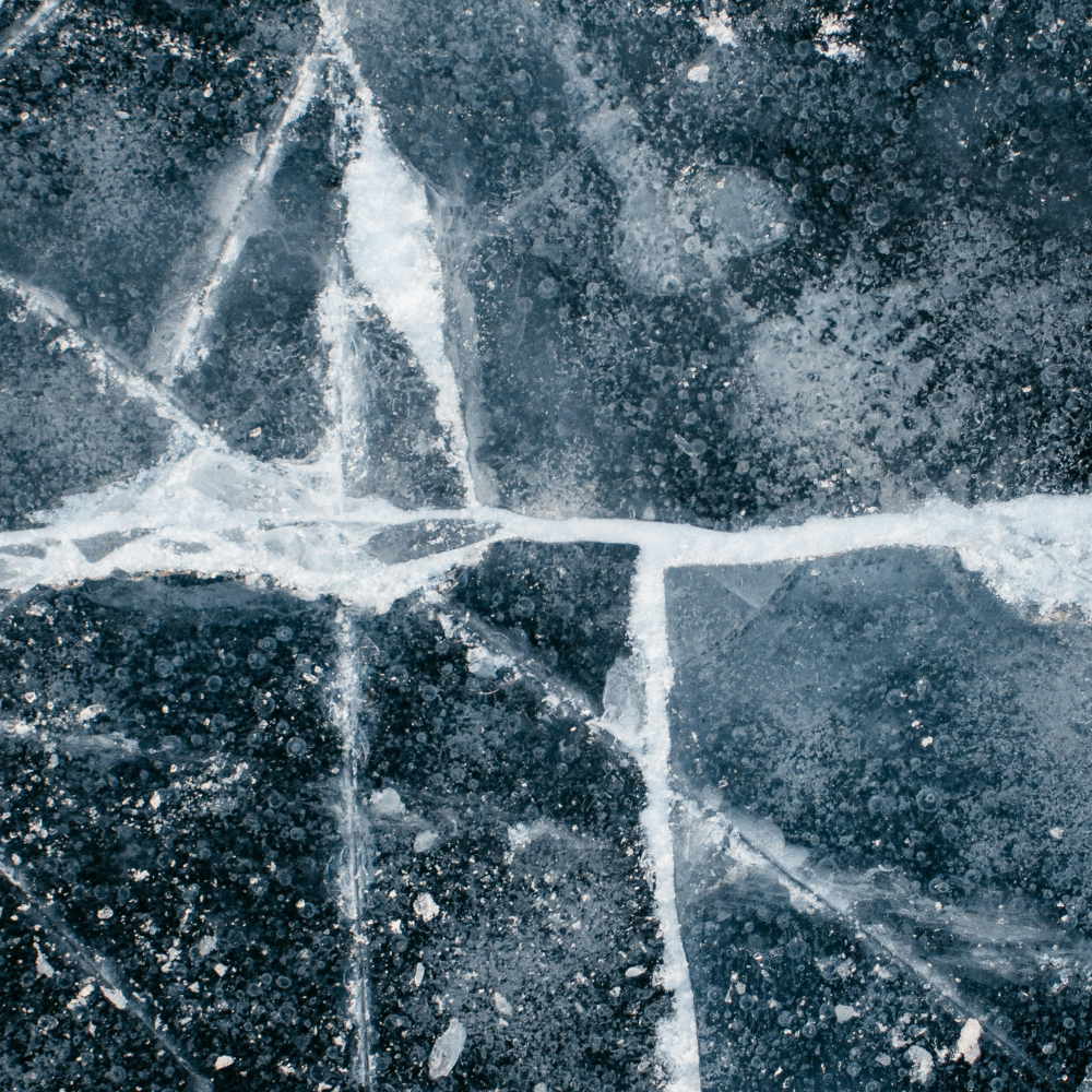 Close-up of ice with crystal formations on a dark background
