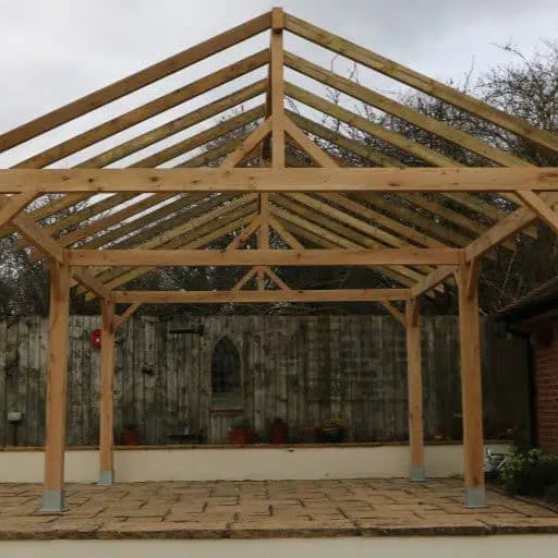 Wooden carport structure under construction with a roof frame.