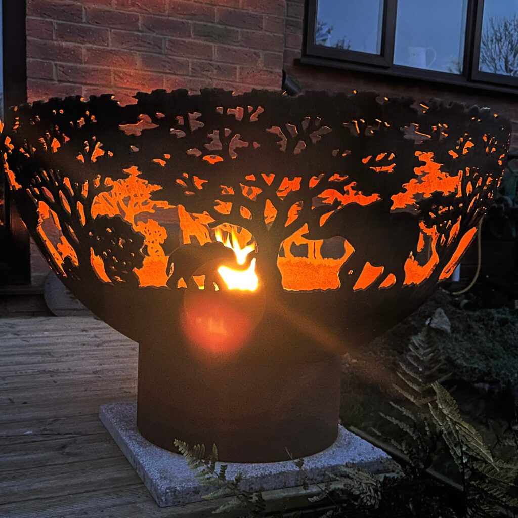 small fire in elephant fire bowl at night