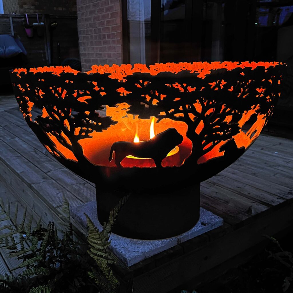 lion style fire bowl with small flame at night in garden